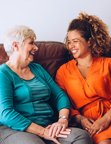 patient and family member sitting laughing