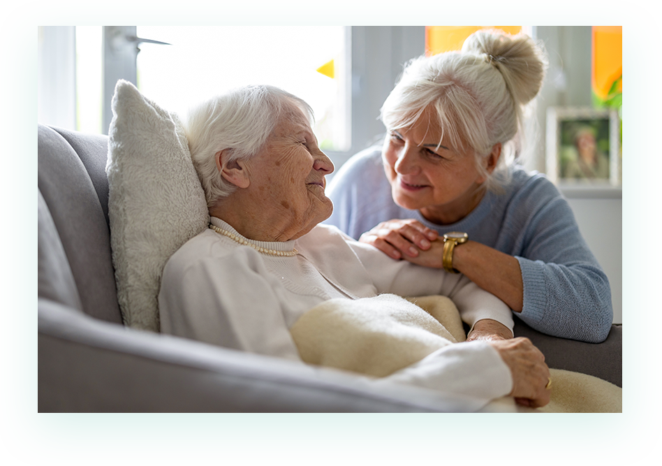 Adult woman caring for elderly patient mother